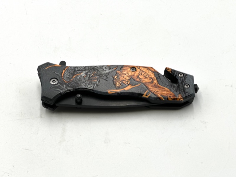 Photo 2 of TIGER AND DRAGON BATTLE DESIGN POCKET KNIFE WITH WINDOW BREAKER AND SEAT BELT CUTTER NEW