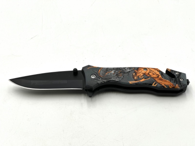 Photo 1 of TIGER AND DRAGON BATTLE DESIGN POCKET KNIFE WITH WINDOW BREAKER AND SEAT BELT CUTTER NEW