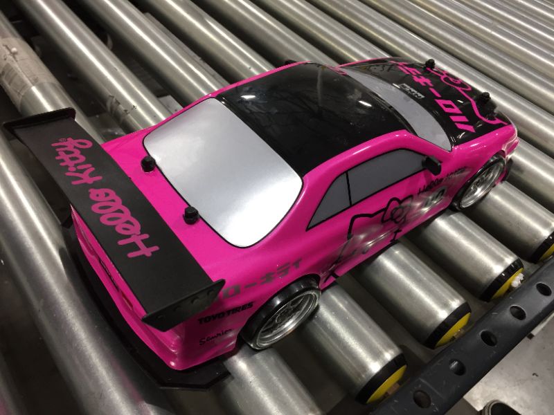 Photo 4 of Jada Toys Hello Kitty Nissan Skyline GT-R Drift Power Slide Elite R/C, USB Charging, with 4 Extra Tires
