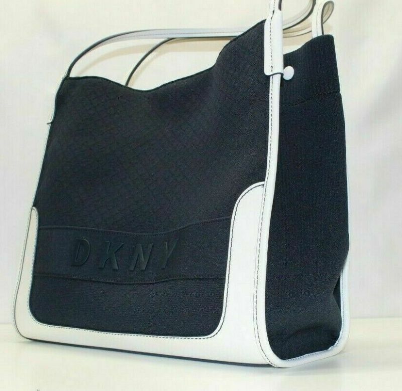 Photo 3 of DKNY Ebony Tote with Pouch
The perfect pick for 9-to-5 and beyond. The DKNY Ebony Tote with Pouch features a casual-cool nylon silhouette with an ultra-spacious interior and bonus zip-top pouch.
Extra-Large sized bag; 21-1/2"W x 13"H x 6"D (width is measu