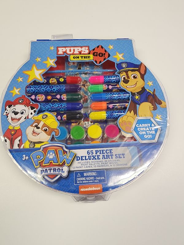 Photo 1 of Paw Patrol 65 Pieces Deluxe Set. Includes: notepads, 28 stickers, paint palette, paint brush, 12 paint cakes, 10 markers & 12 crayons