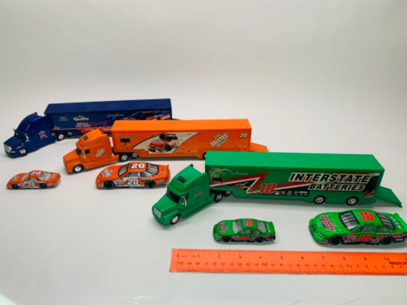 Photo 1 of 3 large die cast trucks with trailers and 4 die cast cars