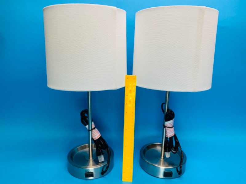 Photo 1 of 776308… 2 stick table lamps with outlet in bases 
