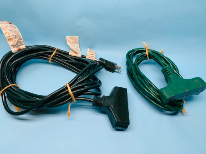 Photo 1 of  802537…2 extension cords- 10 and 25 foot with 3 plug in outlets on each 