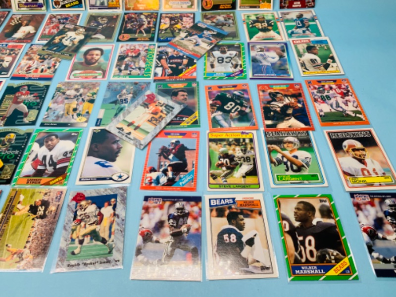 Photo 2 of 802706…70 misc football cards in plastic sleeves 