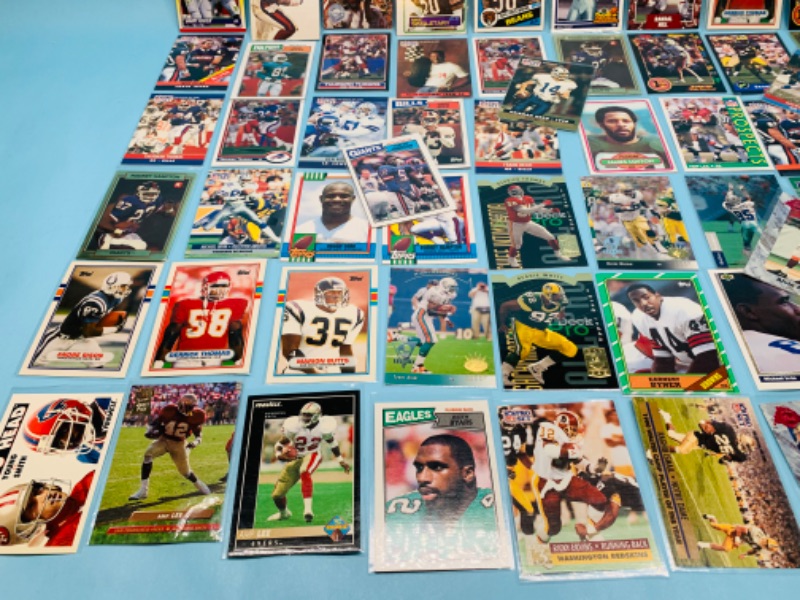 Photo 4 of 802706…70 misc football cards in plastic sleeves 