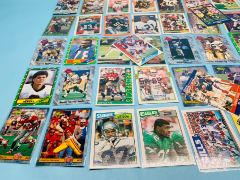 Photo 6 of 802707…60 misc football cards in plastic sleeves 