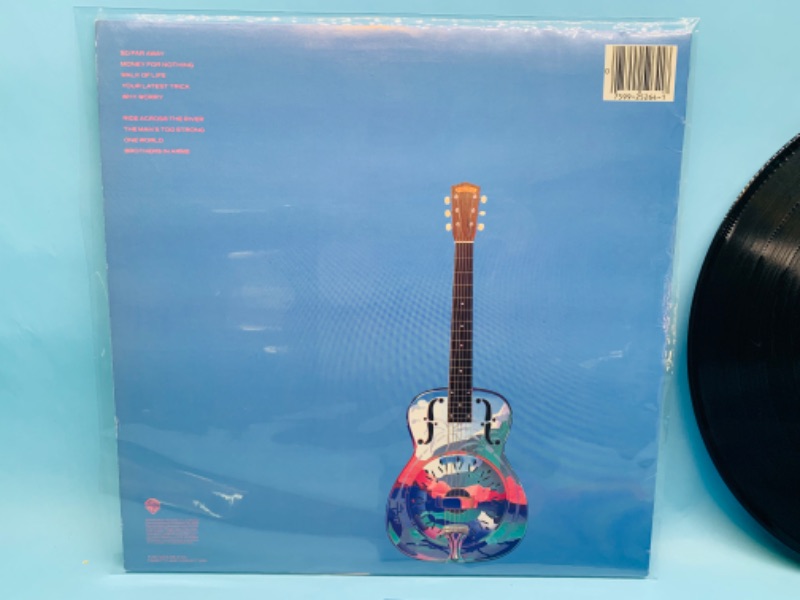 Photo 2 of 802810…great condition dire straits vinyl record in plastic sleeve cover and record in great condition for age 