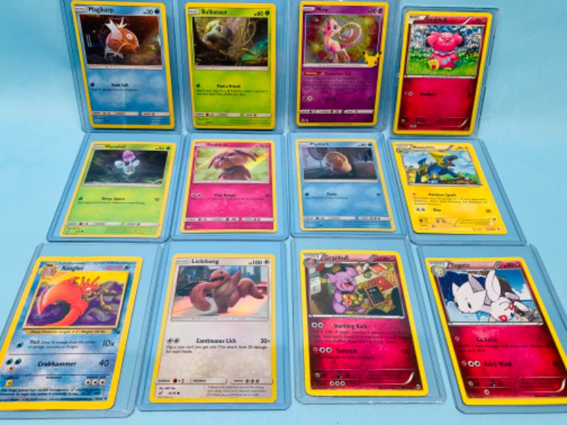 Photo 1 of 803252…12 Pokémon trading cards some holo in hard plastic sleeves 