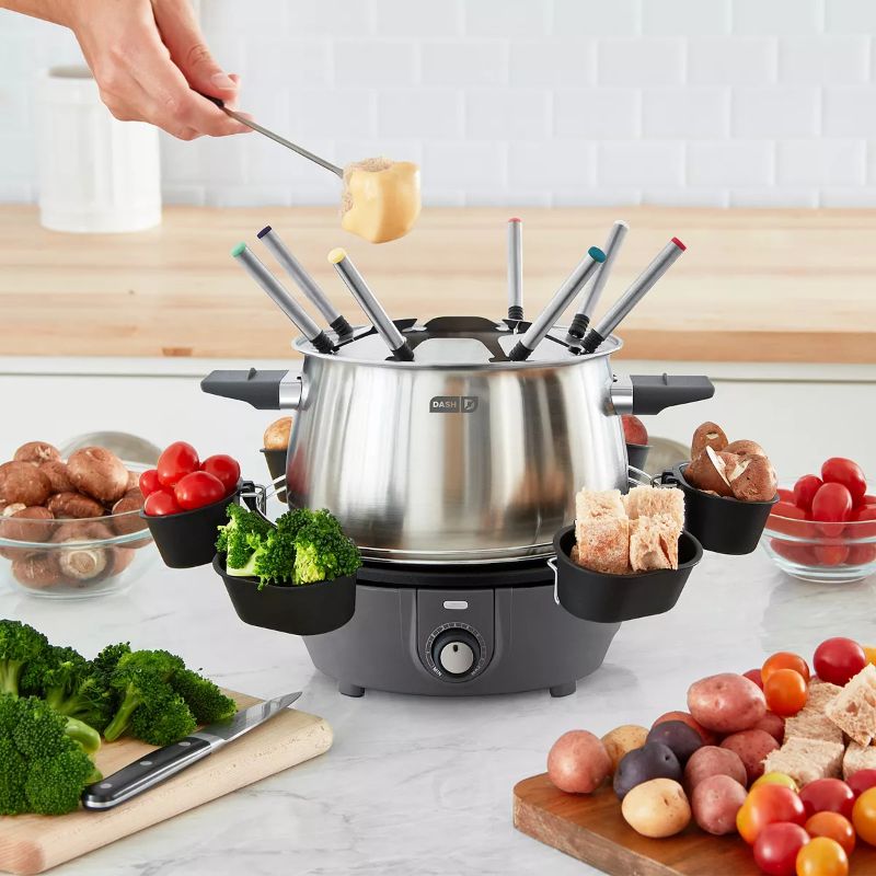 Photo 1 of Dash Deluxe Fondue Maker. Entertaining is easy and delicious with this deluxe fondue maker from Dash. It features a three-quart capacity and a nonstick interior perfect for cheese, chocolate and more. It includes fondue cups for serving up fruits, veggies