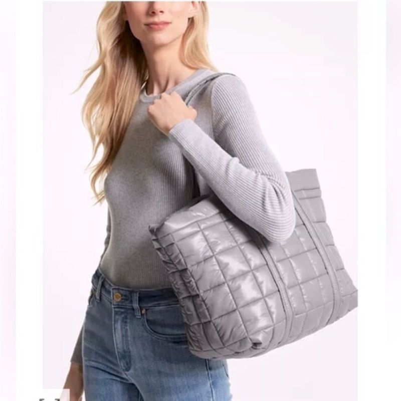 Photo 2 of Michael Kors Stirling Large Puffy Tote. Michael Kors Ladies Tote. Color: Grey. Michael Kors Stirling Large Quilted Padded Tote Bag - Grey. A quilted tote bag from Michael Kors features dual top carry handles, one main internal compartment and a silver-ton