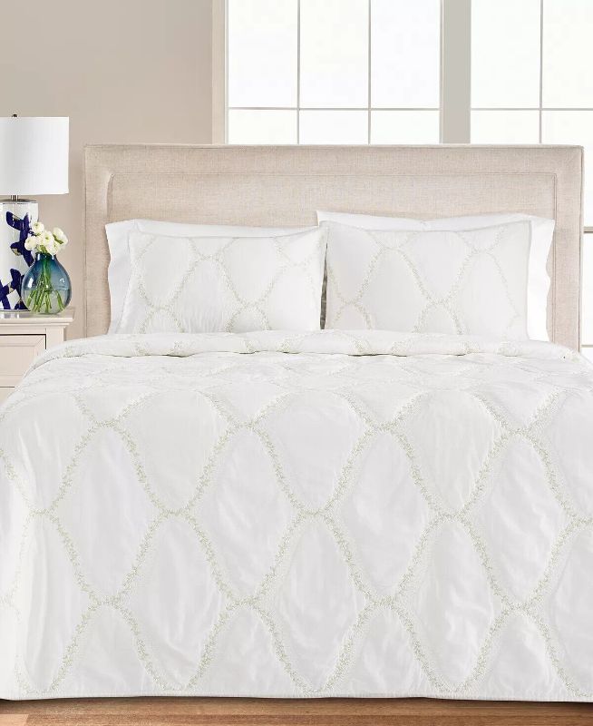 Photo 2 of QUEEN - Floral Embroidered Geo Quilt Quilt, Full/Queen - White - 100% Cotton. Layer it in with the all over stripe, or flip it over to stand on its own!  This reversible yarn dye pinwheel patchwork will bring a fresh spring feeling to your bedroom.
Quilt 