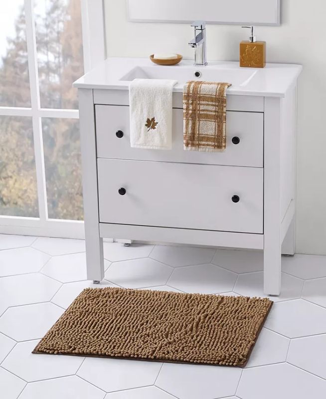 Photo 1 of Harvest Plaid 5 Piece Bath Set. Give your bathroom décor a cozy fall feel with the Seventh Studio Harvest Plaid Bath Set. This autumn-inspired set includes plaid and leaf hand towels, a decorative soap dispenser and dish, and a soft noodle bath rug to com