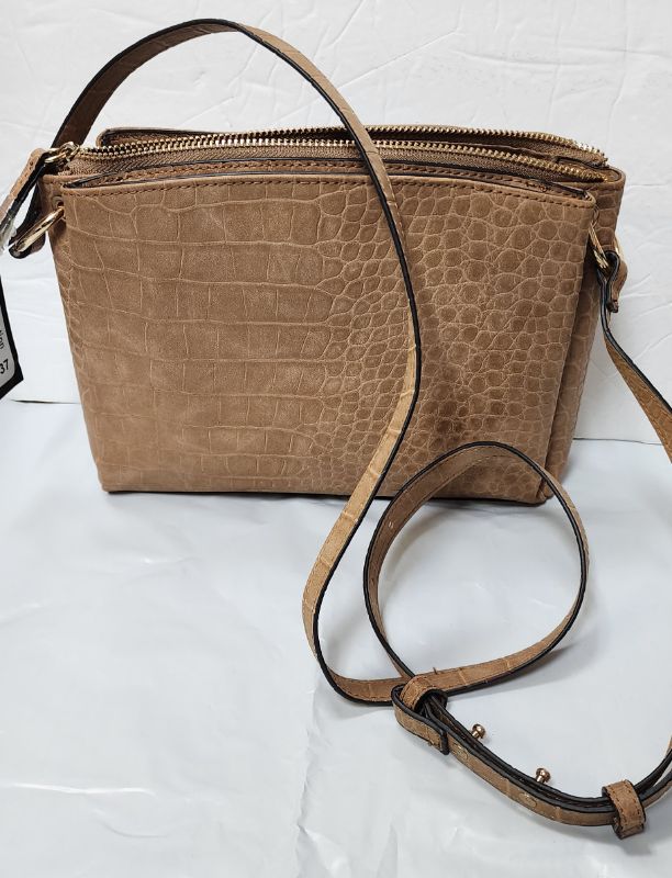 Photo 1 of ALFANI Joselynn Textured Croc Embossed Women's Crossbody Bag Camel
Dimensions: 10" W x 7" H x 2.5" D  (25.5 cm W x 18.75  cm H x 6.5 cm D)
Closure: Magnetic snap buttons and zipper.
Fabric: Faux-leather
Strap type: Adjustable crossbody strap (non-detachab