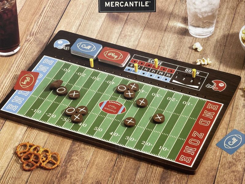 Photo 1 of Studio Mercantile Football Playmaker Strategy Board Game Set. The Studio Mercantile football strategy board is a game. Design plays and draw cards to advance the game and see who could be the next great coach on Sundays. Dimension - 18.98" L x 2.17" W x 1