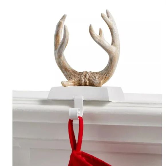 Photo 1 of Stocking holder Frosty texturing crowns the rustic look of the Holiday Lane Antlers stocking holder that brings lodge-like flair to a festive mantel.