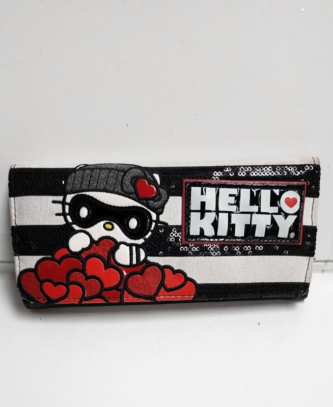 Photo 5 of LOUNGEFLY X SANRIO HELLO KITTY TOTE AND WALLET BANDIT COLLECTION
LIKE NEW CONDITION