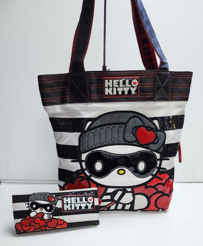 Photo 1 of LOUNGEFLY X SANRIO HELLO KITTY TOTE AND WALLET BANDIT COLLECTION
LIKE NEW CONDITION