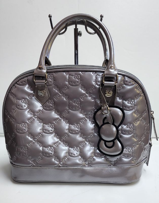 Photo 1 of LOUNGEFLY X SANRIO HELLO KITTY LARGE EMBOSSED DOME HANDBAG WITH DUST BAG
LIKE NEW CONDITION