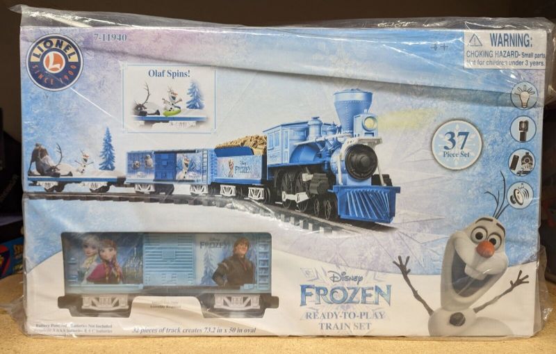 Photo 3 of Lionel Disney's Frozen Battery-powered Model Train Set Ready to Play w/ Remote. A true Disney classic, the magic of Frozen can be enjoyed all year long. Join Olaf & Sven as they ride along on an animated flatcar for a frozen adventure. Battery-powered Gen