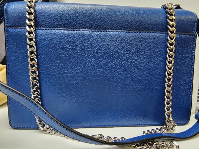 Photo 2 of DKNY Elissa Small Shoulder Flap BlueSliver. A playful charm locks up contemporary-chic style with this leather Elissa shoulder bag from DKNY.
Small sized bag; 10-1/2"W x 7-1/2"H x 3"D; (width is measured across the bottom of handbag); 1.75 lbs. approx. we