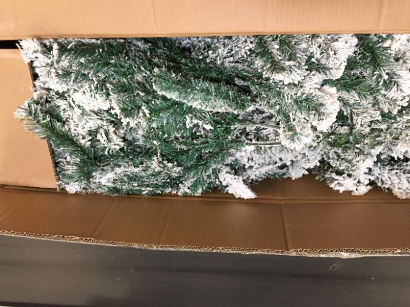 Photo 1 of fake christmas tree with fake snow on it 