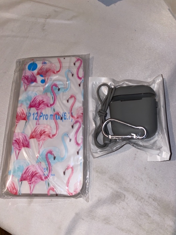 Photo 1 of 2PC LOT
IPHONE 12 PRO MAX CASE, PINK FLAMINGO

GREY SILICONE AIRPOD CASE WITH HEADPHONE CORD AND KEY CHAIN 
