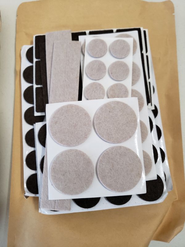 Photo 1 of Amazon Basics Felt Furniture Pads, Beige and Brown, 133 pcs. LOT OF 2.
