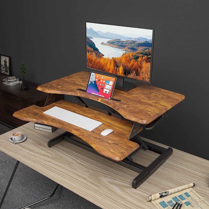 Photo 1 of FEZIBO Standing Desk with Height Adjustable 34 inches Standing Desk Converter Stand up Riser Tabletop Workstation Fits Dual Monitor Dark Brown
