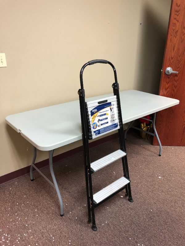 Photo 1 of portable table and 3 step ladder used sold as is 