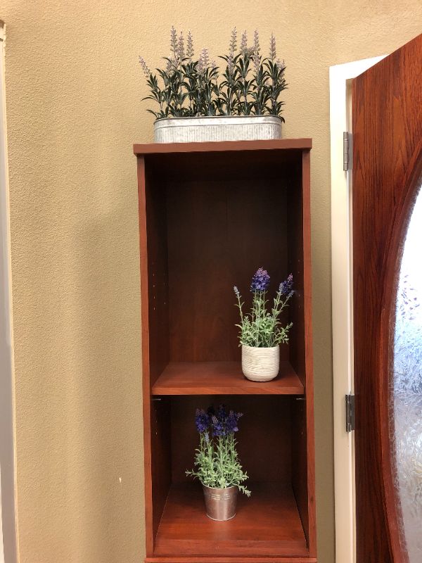 Photo 2 of large wooden cabinet with artificial decorative plants sold as is 