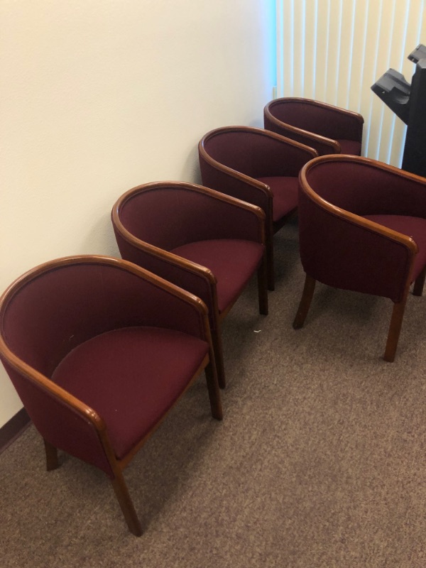 Photo 1 of 5 Red Cushioned Chairs with Wooden Armrests and legs.