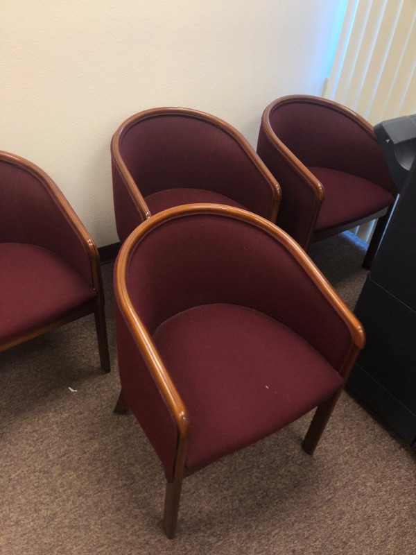 Photo 2 of 5 Red Cushioned Chairs with Wooden Armrests and legs.