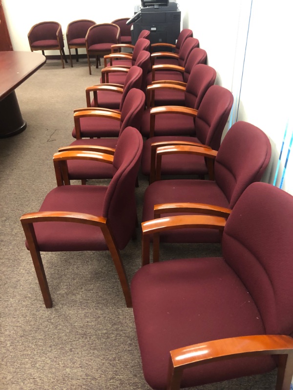 Photo 1 of 13 Red Cushioned chairs with Wooden armrests and legs.