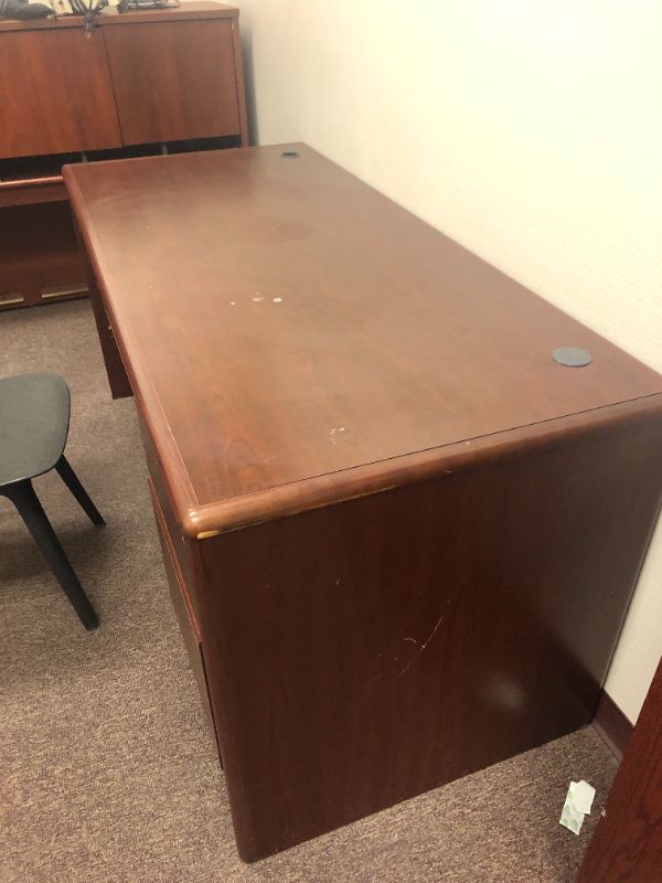 Photo 2 of Oversized office desk with black chair.