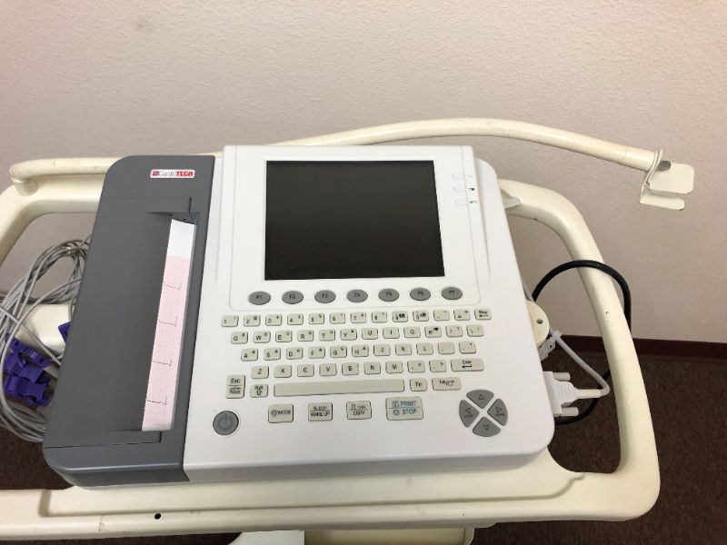 Photo 1 of Cardiotech ekg machine with rolling cart.