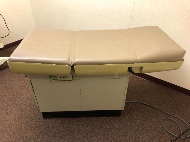 Photo 1 of Midmark 404 medical exam table.