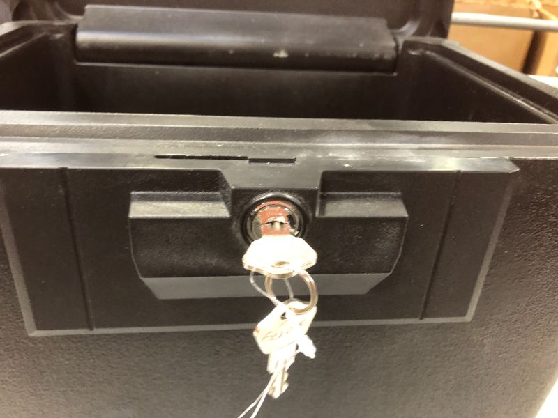 Photo 1 of a piece from the inside lock  is bent is hard to opened--Sentry Safe Security Fire File - Black