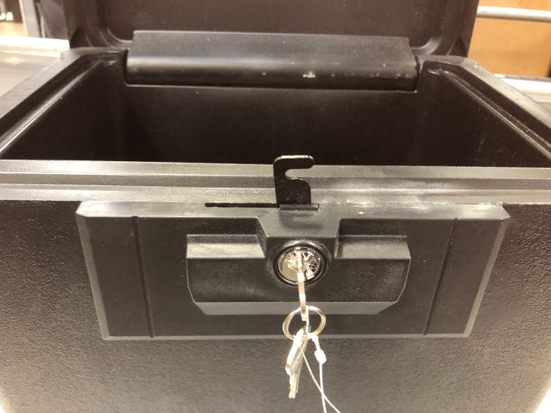 Photo 1 of a piece from the inside lock  is bent is hard to opened--Sentry Safe Security Fire File - Black