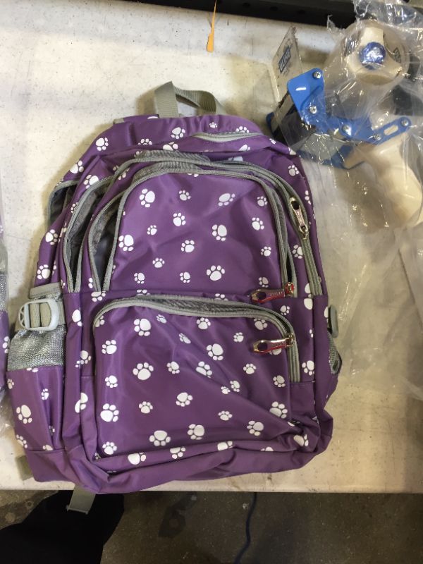 Photo 1 of backpack color purple with dog paw themed 