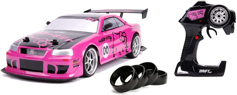 Photo 1 of Jada Toys Hello Kitty Nissan Skyline GT-R (Bnr34) Drift Power Slide Elite R/C, USB Charging, with 4 Extra Tires, Pink
