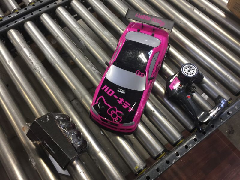 Photo 4 of Jada Toys Hello Kitty Nissan Skyline GT-R (Bnr34) Drift Power Slide Elite R/C, USB Charging, with 4 Extra Tires, Pink
