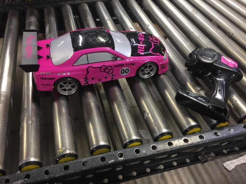 Photo 3 of Jada Toys Hello Kitty Nissan Skyline GT-R (Bnr34) Drift Power Slide Elite R/C, USB Charging, with 4 Extra Tires, Pink
