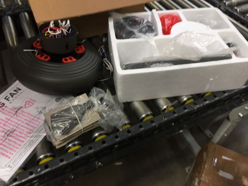 Photo 1 of ceiling fan unit --parts only --includes the motor and some blades with manual