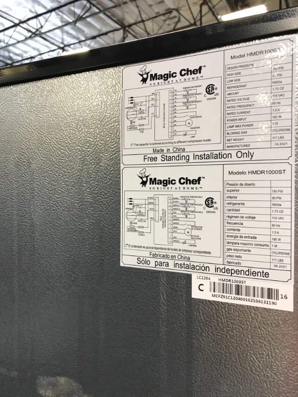 Photo 8 of 10.1 cu. ft. Top Freezer Refrigerator in Platinum Steel- dents around the bottom of fridge 
