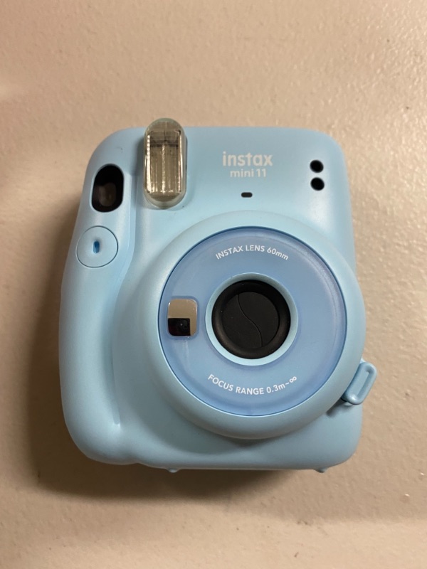 Photo 1 of Instax mini 11. Missing battery cover see photos.