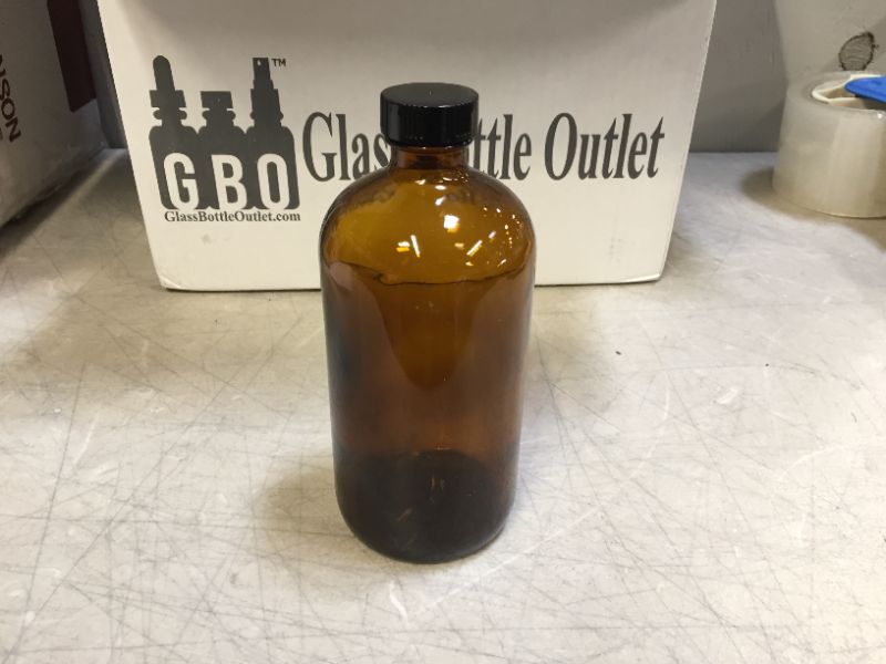 Photo 1 of (Pack of 12) 8 oz. Amber Boston Round with Black Poly Cone Cap
