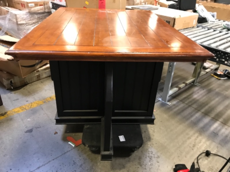 Photo 3 of 54in W X 40in D X 36in H 4 SEATER TABLE WOODEN. DARK WOOD STAIN TOP WITH BROWN BLACK PAINTED BOTTOM.  2 DRAWERS WITH SMALL CUBBY ON 2 SIDES. WITH SPLIT ON THE OTHER 2