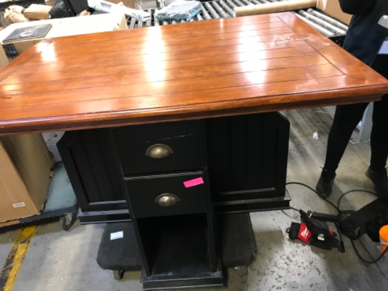Photo 1 of 54in W X 40in D X 36in H 4 SEATER TABLE WOODEN. DARK WOOD STAIN TOP WITH BROWN BLACK PAINTED BOTTOM.  2 DRAWERS WITH SMALL CUBBY ON 2 SIDES. WITH SPLIT ON THE OTHER 2