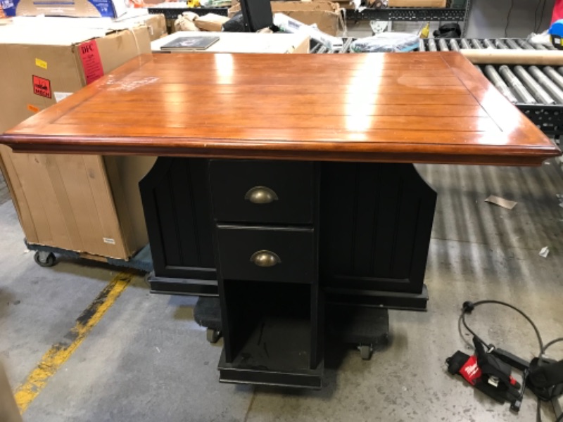 Photo 2 of 54in W X 40in D X 36in H 4 SEATER TABLE WOODEN. DARK WOOD STAIN TOP WITH BROWN BLACK PAINTED BOTTOM.  2 DRAWERS WITH SMALL CUBBY ON 2 SIDES. WITH SPLIT ON THE OTHER 2
